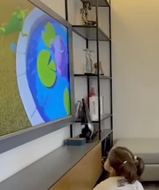 A child enjoying an animated story at home