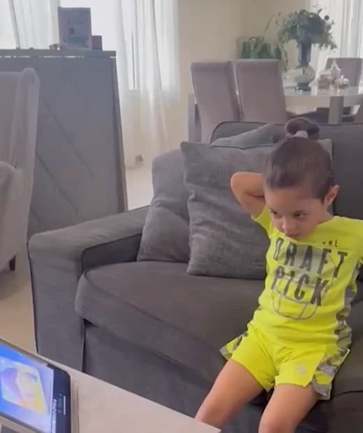 A child enjoying an animated story at home