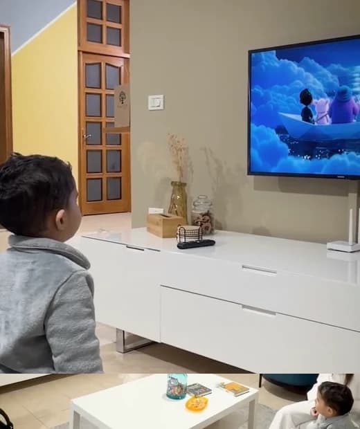 A child enjoying an animated story at home