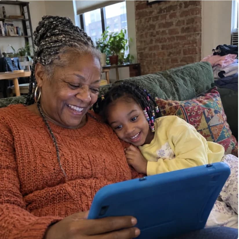 A grandmother and child sharing a story on a tablet